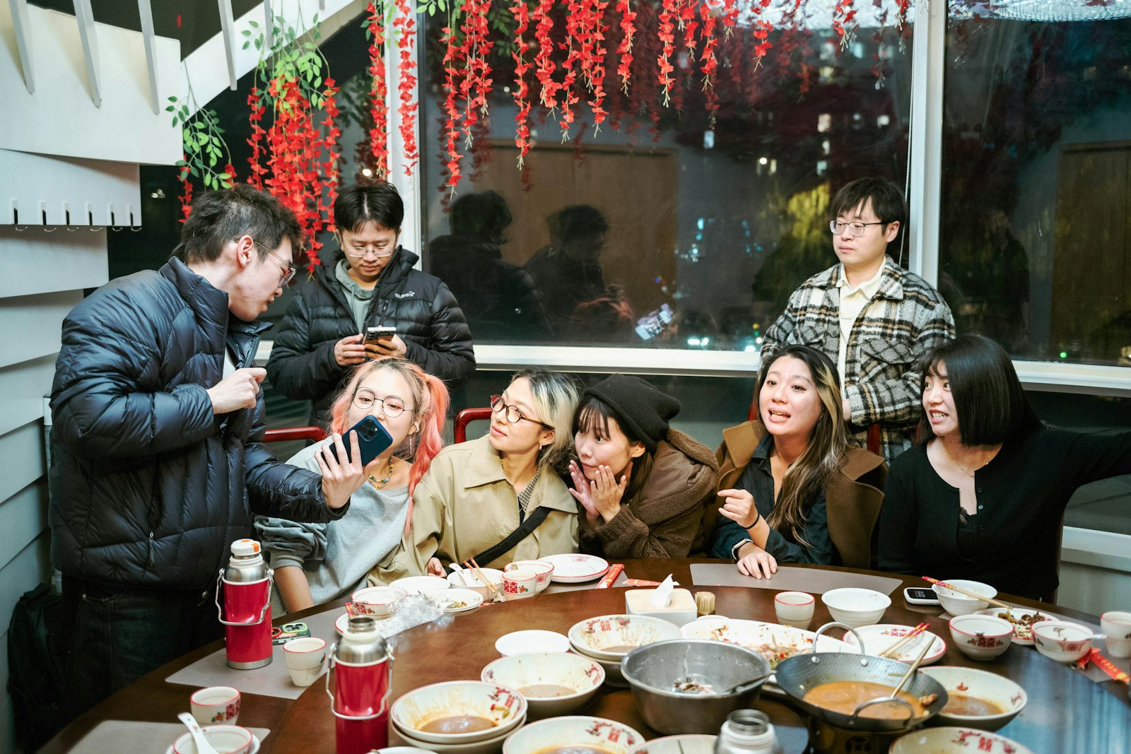 Group of friends around a round table for a Chinese family-style dinner