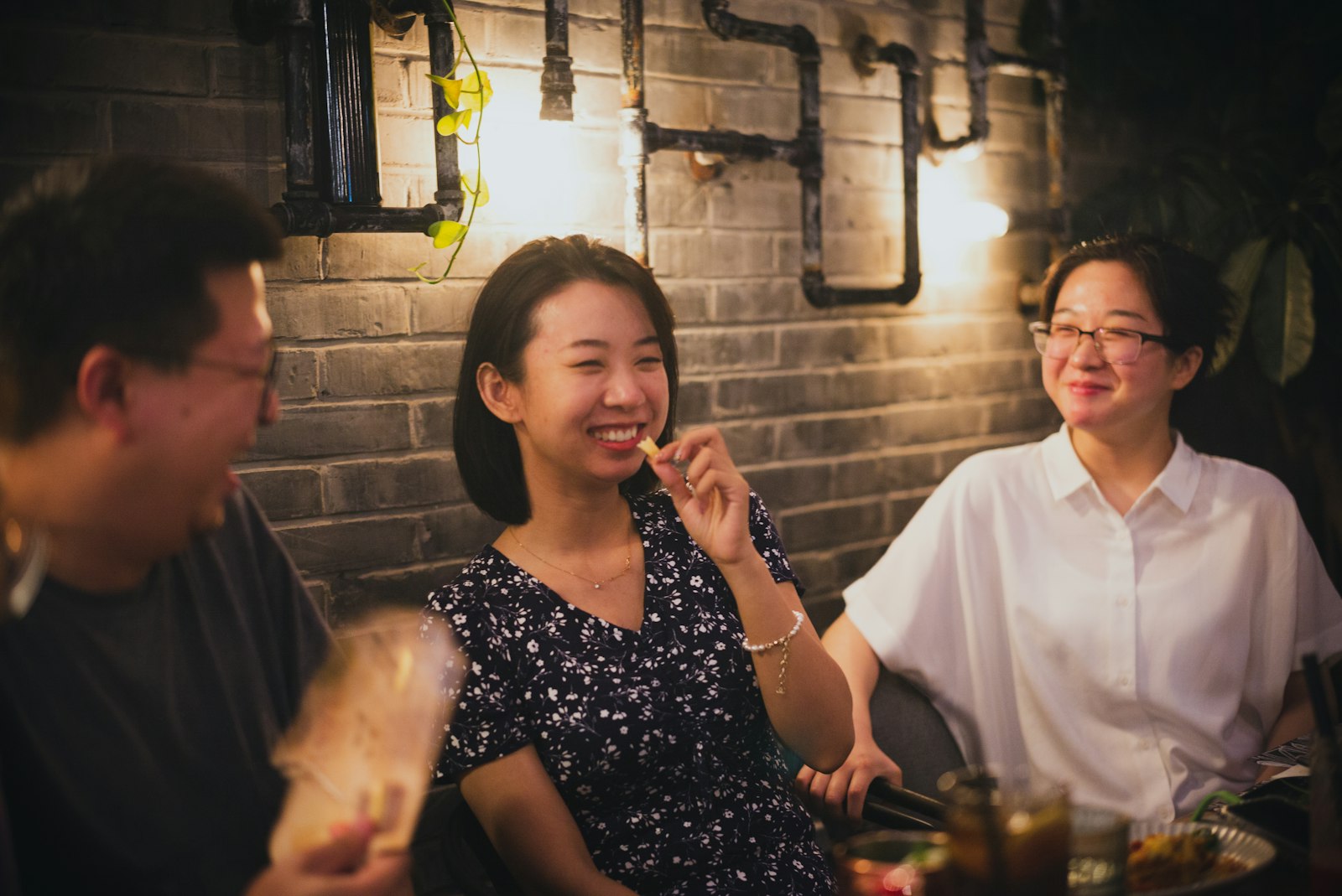 Friends laughing over dinner at a Chinese restaurant