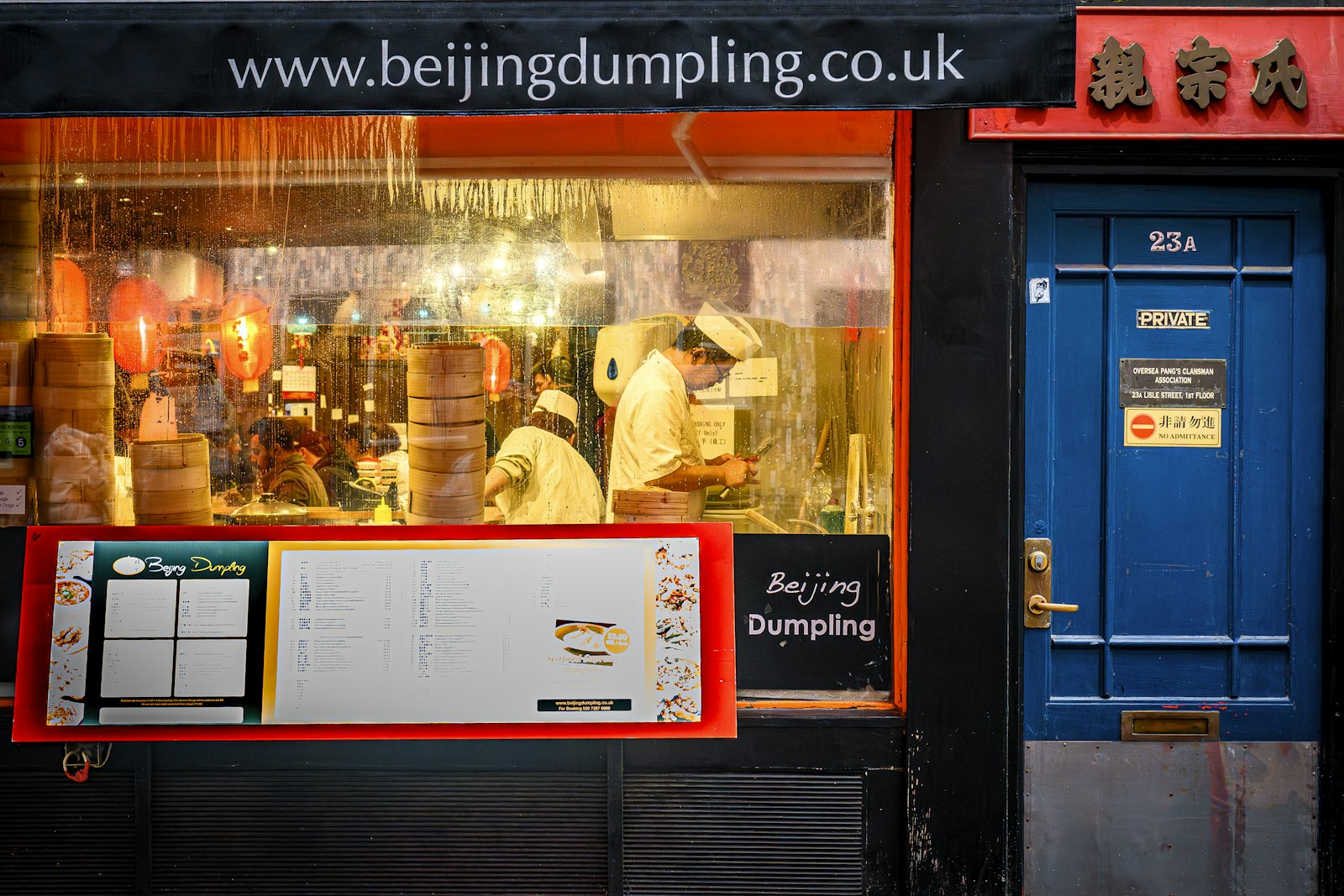 Chefs folding dumplings by hand in a restaurant kitchen