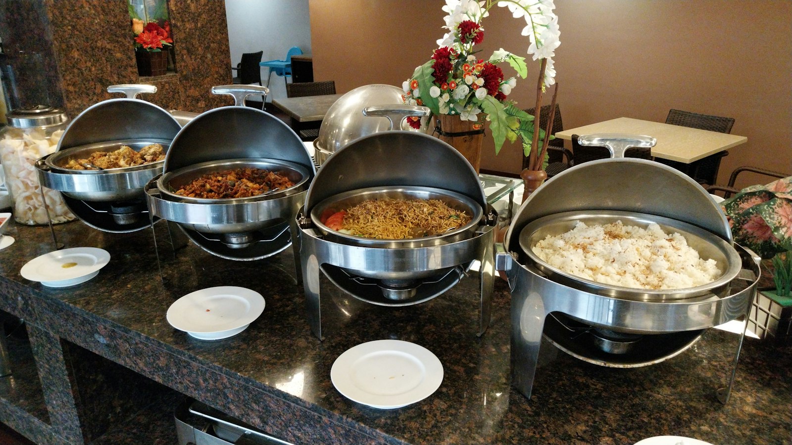Buffet line with trays of hot dishes