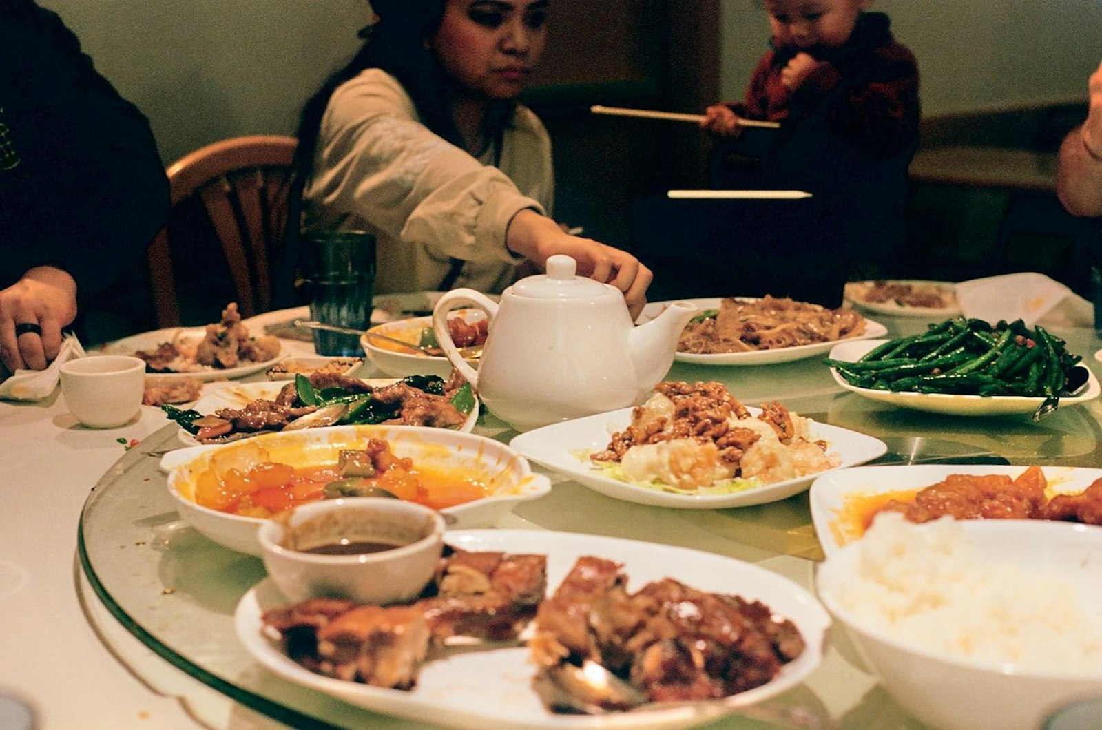A group of people sharing a table full of dishes at a family feast