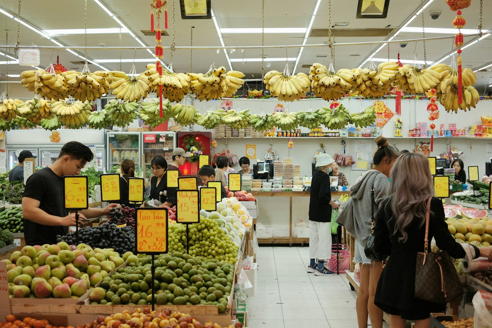 Shoppers in the produce section of a large Asian supermarket